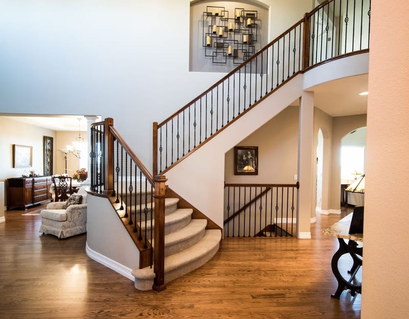 Curved staircase and foyer inside a home